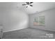 This spacious bedroom features soft carpeting, neutral paint, and two large windows for natural light at 11109 Pond Valley Ct, Charlotte, NC 28269