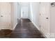 Bright foyer showcasing dark wood-look floors, a white front door and a glimpse into other rooms at 11109 Pond Valley Ct, Charlotte, NC 28269