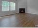 Bright living room with fireplace and wood floors for cozy gatherings at 11109 Pond Valley Ct, Charlotte, NC 28269