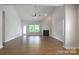 Spacious living room featuring a fireplace, wood floors, and a ceiling fan at 11109 Pond Valley Ct, Charlotte, NC 28269