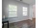 Bright, inviting living room featuring wood-look floors, neutral paint, and large windows at 11109 Pond Valley Ct, Charlotte, NC 28269
