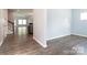 Open-concept living room featuring wood-look floors, neutral paint, and views into the kitchen at 11109 Pond Valley Ct, Charlotte, NC 28269