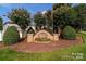 Hicks Landing entrance sign with flowering trees, shrubbery and mulch on a sunny day at 11109 Pond Valley Ct, Charlotte, NC 28269