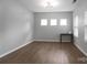 Office space with wood-look floors, neutral paint, three windows, and table, creating a functional area at 11109 Pond Valley Ct, Charlotte, NC 28269