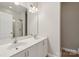 Bathroom featuring double sinks with modern fixtures, shower with glass door, and ample lighting at 1126 Dean Hall Ln, Matthews, NC 28105