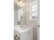 Bright bathroom vanity with white cabinets, a large mirror, and ample lighting at 1126 Dean Hall Ln, Matthews, NC 28105