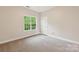 Bright bedroom with a large window, offering a peaceful view of the outdoors at 1126 Dean Hall Ln, Matthews, NC 28105