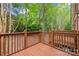 Wooden deck overlooks a private backyard surrounded by lush greenery, offering a serene outdoor space at 1126 Dean Hall Ln, Matthews, NC 28105