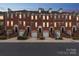 Charming brick townhomes with individual garages, front stairs, and well-maintained landscaping create inviting curb appeal at 1126 Dean Hall Ln, Matthews, NC 28105