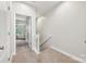 Hallway with carpet and white railings lead to other rooms in the home at 1126 Dean Hall Ln, Matthews, NC 28105