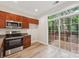 Bright kitchen featuring stainless appliances, wood cabinets and walk out access to the back deck at 1126 Dean Hall Ln, Matthews, NC 28105