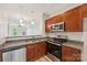 Stylish kitchen featuring stainless steel appliances, granite countertops, and access to the main living area at 1126 Dean Hall Ln, Matthews, NC 28105