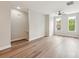 Open living area with hardwood floors, staircase, and large windows showcases bright, neutral color palette at 1126 Dean Hall Ln, Matthews, NC 28105