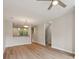 Bright living room featuring modern ceiling fan, hardwood floors, and staircase with plenty of natural light at 1126 Dean Hall Ln, Matthews, NC 28105