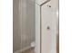 Modern bathroom shower with a glass door, and white tiled walls at 1126 Dean Hall Ln, Matthews, NC 28105