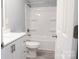 A bright bathroom featuring a modern vanity, toilet, and shower with white tile at 1184 Sherwood Rd, Clover, SC 29710