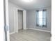 Comfortable bedroom featuring a window with curtains, updated floors, and closet at 1184 Sherwood Rd, Clover, SC 29710