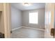 Sunlit bedroom featuring neutral walls, modern floors and trim, plus a large window at 1184 Sherwood Rd, Clover, SC 29710