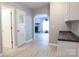 Inviting hallway leads to a bright living area with a stone fireplace and white-painted door at 1184 Sherwood Rd, Clover, SC 29710