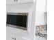 Close-up of a modern microwave and granite countertop in a well-appointed kitchen at 1184 Sherwood Rd, Clover, SC 29710