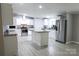 Modern kitchen features stainless steel appliances, an island, granite countertops, and white cabinets at 1184 Sherwood Rd, Clover, SC 29710