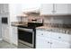 Updated kitchen featuring stainless steel appliances, granite countertops, and white cabinetry at 1184 Sherwood Rd, Clover, SC 29710