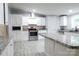 Well-equipped kitchen with stainless steel appliances, white cabinetry, and a granite-topped island at 1184 Sherwood Rd, Clover, SC 29710