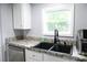 A modern kitchen sink and granite countertops are featured in this well-lit kitchen at 1184 Sherwood Rd, Clover, SC 29710