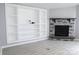 Living room with a stone fireplace and built-in white shelves on a grey wall at 1184 Sherwood Rd, Clover, SC 29710