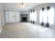 Bright living room featuring a fireplace, built-in shelving, and large windows with curtains at 1184 Sherwood Rd, Clover, SC 29710