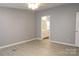Bright main bedroom with modern vinyl floors leading into the ensuite bathroom at 1184 Sherwood Rd, Clover, SC 29710