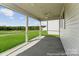 Covered patio with ceiling fan overlooking lush greenery and open space at 125 Tangle River Dr # 51, Statesville, NC 28677
