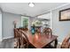 Dining room with wood table and chairs next to a kitchen with modern lighting at 12504 Culp Rd, Gold Hill, NC 28071