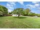 Farmhouse-style home surrounded by a well-maintained grassy lot and mature trees at 12504 Culp Rd, Gold Hill, NC 28071