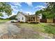Side exterior view of home featuring a screened porch, white siding, gravel driveway, and partial lawn at 12504 Culp Rd, Gold Hill, NC 28071