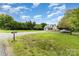 A farmhouse-style house on a grassy lot with a long driveway and mature trees at 12504 Culp Rd, Gold Hill, NC 28071