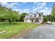 Farmhouse-style home featuring a well-manicured lawn and gravel driveway at 12504 Culp Rd, Gold Hill, NC 28071