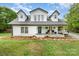 Charming two-story farmhouse with a welcoming front porch and manicured lawn at 12504 Culp Rd, Gold Hill, NC 28071