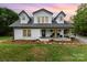 Charming two-story farmhouse with a welcoming front porch and manicured lawn at 12504 Culp Rd, Gold Hill, NC 28071
