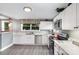 Bright kitchen features white cabinets, stainless steel appliances, modern countertops, and ample natural light at 12504 Culp Rd, Gold Hill, NC 28071