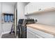 Functional laundry room with modern washer/dryer, counter space, and storage at 12504 Culp Rd, Gold Hill, NC 28071