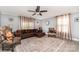Comfortable living room with a large leather sectional, ceiling fan, and natural light at 12504 Culp Rd, Gold Hill, NC 28071