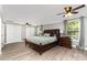Spacious main bedroom featuring wood floors, ceiling fan, and a large window at 12504 Culp Rd, Gold Hill, NC 28071