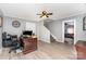 Office featuring a ceiling fan, wood desk, staircase and entryway to living room at 12504 Culp Rd, Gold Hill, NC 28071