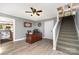 Office featuring a ceiling fan, wood desk and stairs with carpet leading to the second floor at 12504 Culp Rd, Gold Hill, NC 28071
