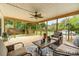 Inviting covered porch featuring wooden floors, a ceiling fan, and comfortable seating area with decorative rug and outdoor view at 12504 Culp Rd, Gold Hill, NC 28071
