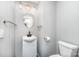 Powder room featuring sink, modern lighting, commode, and modern fixtures at 12504 Culp Rd, Gold Hill, NC 28071