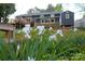 Beautiful backyard featuring vibrant white flowers and a well-maintained home with deck at 132 Marina Ln, Mooresville, NC 28117
