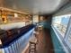 Unique bar area with wood paneling, a blue countertop, wooden stools, and a small round table at 132 Marina Ln, Mooresville, NC 28117