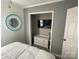 Cozy bedroom with a decorative mirror, white bedding, and closet with TV at 132 Marina Ln, Mooresville, NC 28117